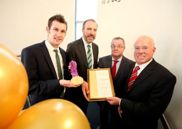 Celebrating LEDCOM achieving its Investors in People Gold status are (from left): Paralympic gold medal champion, Michael McKillop; LECOM CEO, Ken Nelson; Bill Gordon, the Assessment Manager of Investors in People Northern Ireland and LEDCOM Chairman, Henry Fletcher. Pic by Paul Moane / Aurora PA