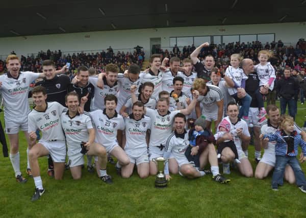 The Castledawson team celebrate their victory in the Intermediate Football Championship at Owenbeg on Sunday. DER4014-202KM
