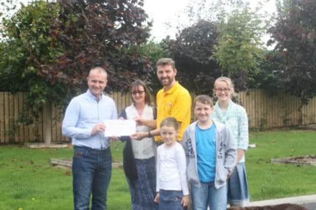 Andrew McCrea (organiser) presenting the cheque to Alma and Rodney Davidson. With Grace, Calvin and Amy Davidson as well.