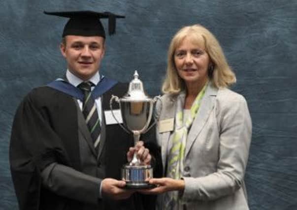 Michael Murphy, aged 22, BSc(Hons) Agricultural Engineering with Marketing and Management, receives the Claas (UK) Trophy from Jane Broomhall, CLAAS Personnel Manager.