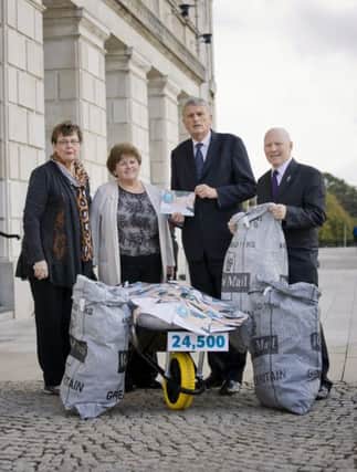 Cancer patients Vera Saunderson (left)and Allister Murphy (right), along with Rosin Foster, Cancer Focus NI chief executive, present a petition of more than 24,000 names to Health Minister Jim Wells  (picture by Brian Morrison). INCT 41-799-CON