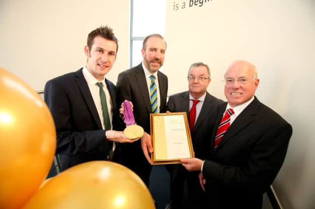 Celebrating LEDCOM achieving its Investors in People Gold status are (from left): Paralympic gold medal champion, Michael McKillop; LECOM CEO, Ken Nelson; Bill Gordon, the Assessment Manager of Investors in People Northern Ireland and LEDCOM Chairman, Henry Fletcher. Pic by Paul Moane / Aurora PA