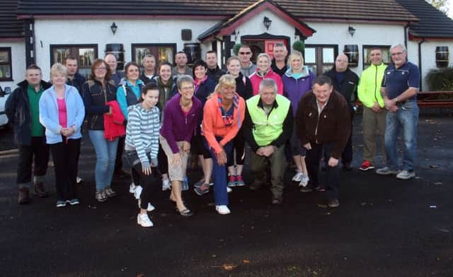 Participants in the Knocklayde mountain climb for the Children's Hospice charity pictured at the Scenic Inn prior to the start. The walk was organised by Ivan King and Robert Stewart (front right) on behalf of Stranocum lass, Jade McAfee. At the forefront areJade's mum, Debbie, and sister, Faith, along with Shirley McKinley of the Scenic. inbm42-14s