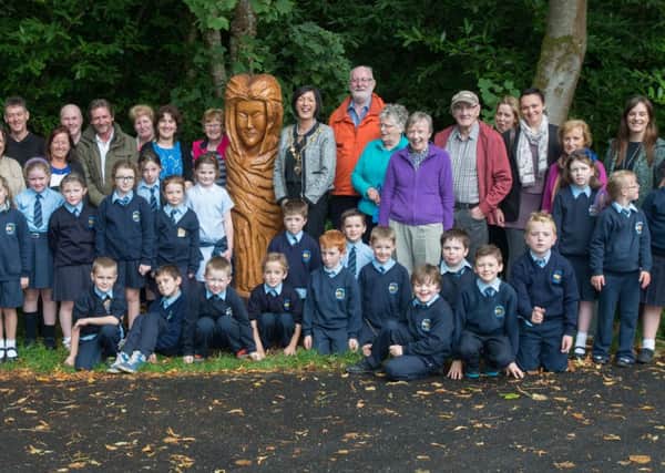 Members of the local community and children from St. Mary's Primary School Altinure, pictured with the figure of a lady which is one of the new sculptures created by Kieran O'Doherty, in Learmount Forest as part of a new Sculpture Trial. Included are Annie Mullen, Derry City Council, the Mayor, Councillor Brenda Stevenson, Jim McColgan, Chair of ARK North West and Caroline Lynch Learmount Community Centre Manager. The sculptures are a project developed by Faughan Valley Landscape Partnership and Learmount Community Development Group with funing from RAPID, the Big Lottery Fund, the Arts Council and Derry City Council. Picture Martin McKeown. Inpresspics.com. 30.09.14
