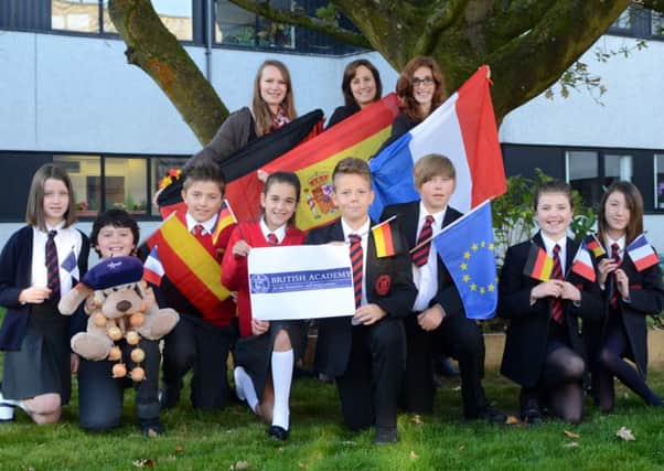 Celebrating success: Language assistants Justine Oriard, Susana Hurtado and Natasha Rettich with Ballyclare Primary and Fairview Primary pupils Olivia White, Harry Catherwood, Luke McIlwrath and Caitlin Meredith, and Ballyclare High pupils Ciaran Bourdet, Stefan Ross, Erin McWilliam and Sophie McFarland.