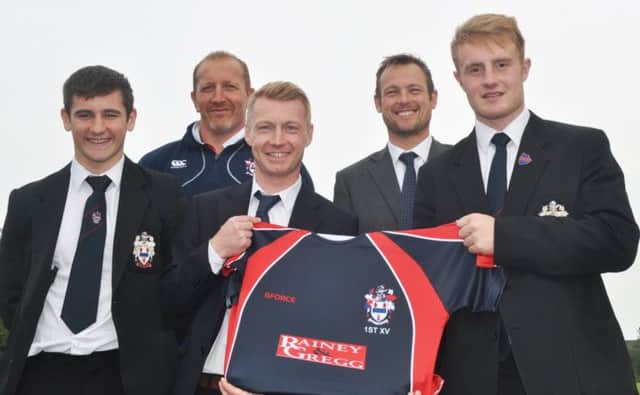 Pictured with the schools new 1st XV jersey are senior players Andy Magrath, Josh McIlroy, coaches John Andrews and Gavin Muray and Mr Ryan Gregg from Rainey & Gregg Property and Mortgage Centre