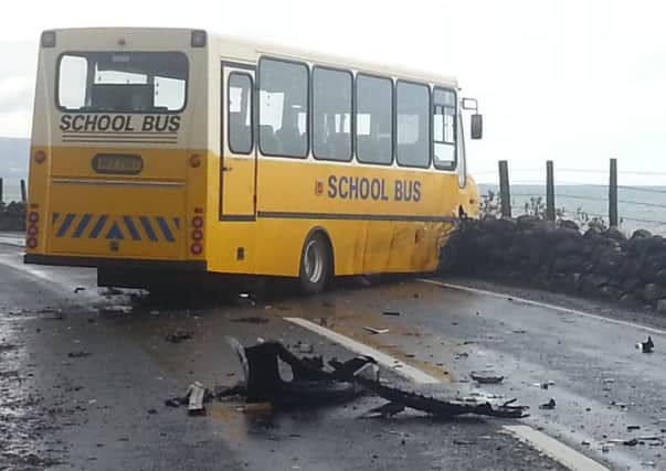 The school bus at the spot where it hit the sea wall on the Antrim Coast Road on Thursday morning, after being in collision with a Peugeot car. INLT 42-627-CON