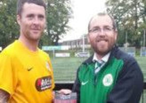 Ryan Henderson receiving his McLeans Man of the Match award from Desi Magennis