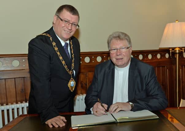Mayor of Larne, Martin Wilson is pictured with the Moderator of the Presbyterian Church, Rev Dr Michael Barry as he signs the visitors book during his visit to the mayor`s parlour. INLT 42-005-PSB