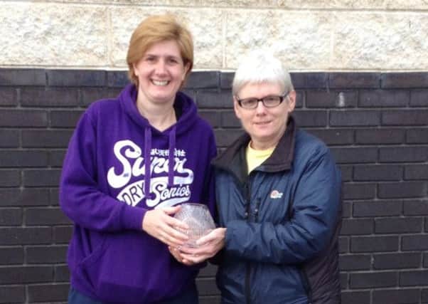 Theresa Evans, winner of Larne AC's Fulton Five handicap race, is presented with her award by Denise Sharratt. INLT 42-904-CON