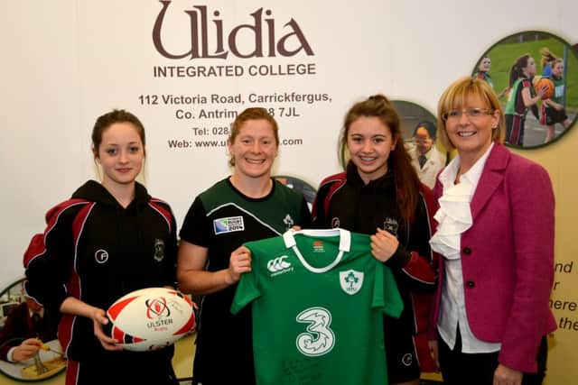 Ireland International rugby player Grace Davitt with Ulidia Integrated College vice-principal Mrs Bonar and students Niambh Ogle and Enya Maguire. INCT 42-108-GR