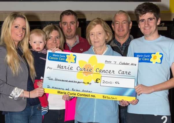 Centrepoint - cheque presentation to Marie Curie in memory of Slyvia Archer's late husband Brian (£2,010).  From left; Alana Archer and baby Joshua Black, Sylvia Archer, Roy Archer, Margaret Coleman, Chairperson of the local Marie Curie Group, Ron Gemmell and Alistair Archer.  INLM4114-409