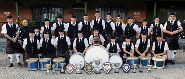 McDonald Memorial Pipe Band pictured on Sunday 12th October with the bands winning silverware.  Included are Norman McDonald jnr, Pipe Major and Norman McDonald snr, Founder and President (left) and Vikki Singer, Drum Major and Ronnie McDonald, Pipe Sergeant (right) and Trevor Clydesdale, Drum Sergeant (left in front row).