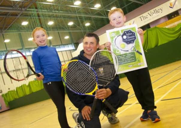 Encouraging children to try the Indoor Tennis Programme at Valley Leisure Centre are Richard Parker (Cavehill Tennis Club) and Aine and Ronan McGoldrick. Booking forms are available from the Valley Leisure Centre. INLT 42-912-CON