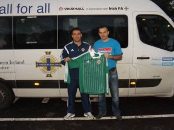 Jordan Scott's father Jonathan receives the signed Northern Ireland shirt from David Healy