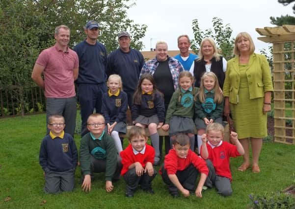 Members of the Caw/Nelson Drive Action Group and the Housing Executives Grounds team with school children from Ebrington, Lisnagelvin  and Oakgrove Primary Schools, who helped plant a herb and fruit garden on the estate.