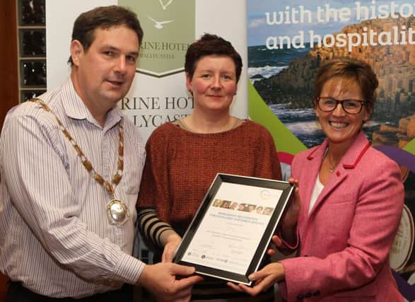 Kathleen from K Co receives Worldhost Recognition for excellent customer service from Cllr Donal Cunningham Chairman of Moyle council and Nikki McQuillan, former co-founder and Director of Streat. INBM43-14 KMA