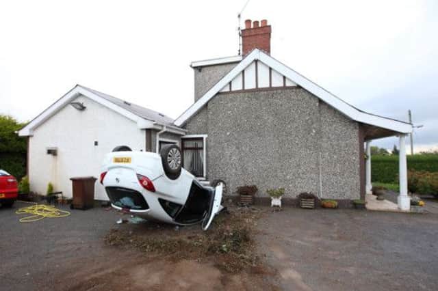 A young woman was fortunate to walk away with only minor injuries after crashing her car into a house on Pond Park Road. Her vehicle crashed through two hedges and travelled the width of a football field and hit the house before coming to a rest on its roof. US1442-534cd  Picture: Cliff Donaldson