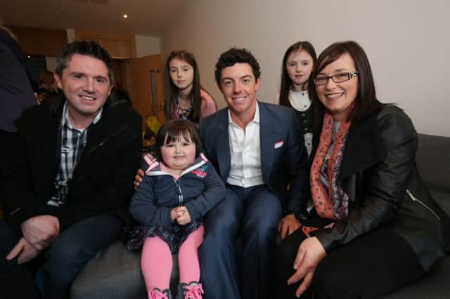 Cookstown girl Cassie McGeehan with top local golfer Rory McIlroy. Cassie, who has been affected by cancer, was invited to watch Rory officially open Cancer Fund for Childrens Daisy Lodge short break facility in Newcastle on October 7. She is pictured here with (from left to right) her dad Kevin, sisters Caoimhe and Cara and her mum Tracey.