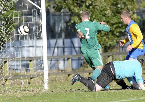 Nortel's John Rosbotham scores after a slip-up by Crumlin Star's goalkeeper Lawrence Mervyn. Photo: Philip McCloy