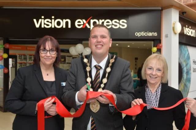 Store Directors Anne and Dorothy (r) Brodison help Lisburn Mayor Clr Andrew Ewing cut the ribbon to officially open the refurbished Vision Express store in Lisburn. 
Photo by Aaron McCracken/Harrisons.