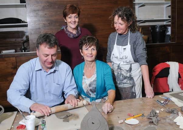 Councillor Wilbert Buchanan Chairman of Cookstown District Council tries his hand at Ceramics. Looking on are workshop participant Frances, Arts & Culture Officer Mary Crooks, and tutor Diane McCormick