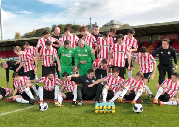 The Derry City FC bench collapses as the team are having pictures taken at the Brandywell on Thursday in preparation for their FAI Ford Cup Final. Picture Margaret McLaughlin