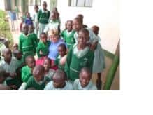 Suzanne surrounded by pupils from Truth Primary. inbm43-14s