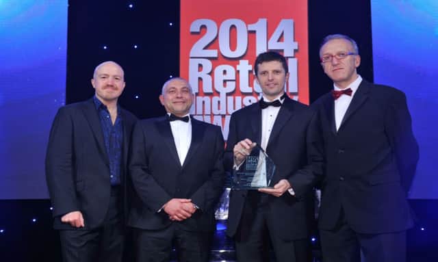 Jonathan Mitchell, store manager of EUROPSAR Carrick Milestone (second right) picks up the Fresh Produce Retailer of the Year (Individual Store) from comedian Andy Parsons, Simon Moulson, head of Retail Sales, Schoeller Allibert and David Shrimpton, editor, Independent Retail News, at the Retail Industry Awards in London. INCT 43-703-CON