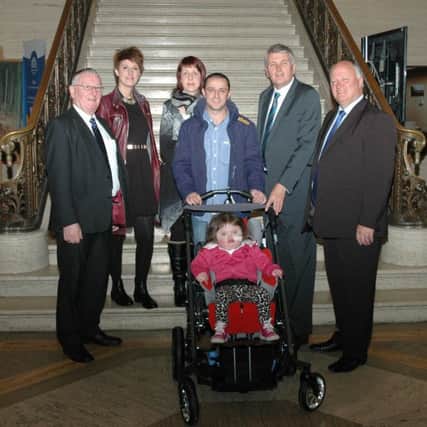 Mr Simpson with the families meeting the Health Minister, including Judith and Aron Mckee and their young daughter Grace.