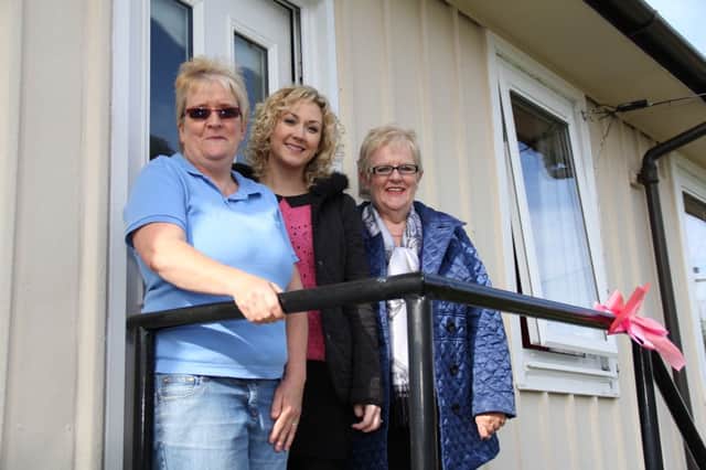 Pictured at her newly double glazed home in Banbridge is Mrs Murray who said she is delighted with her new double glazing which has make a difference to the house.  Also featured are Grainne Hall of Bann Ltd and Margaret Hassan from the Housing Executive.
