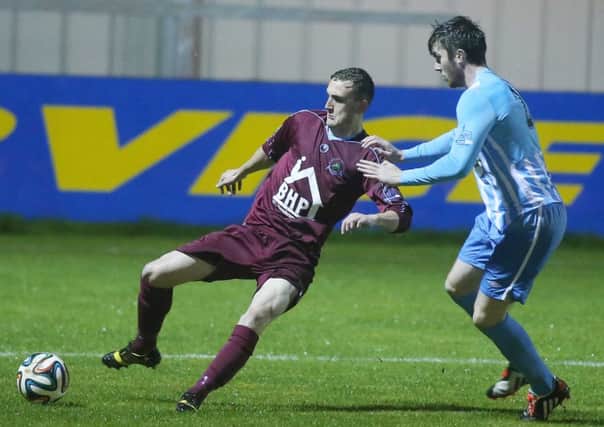 Institute defender Stephen O'Donnell clears his lines before Warrenpoint Town's Jonathan Breen could challenge. Picture by Jonathan Porter/Presseye.com