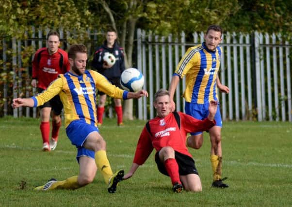 Woodlands FC's Ross Oliver (left) and Paul Addis (right) close down their Mallusk opponent.
