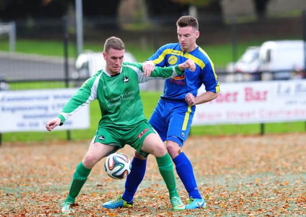 Moyola Park's Mark Waddell blocks ou this Newington attack during Saturday's league clash at Mill Meadow.INMM4314-386