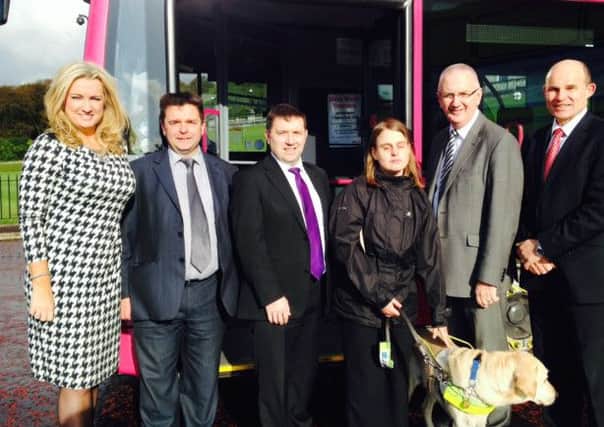 North Antrim UUP MLA Robin Swann, centre, joins fellow Assembly members Jo-Anne Dobson, Andrew Murdock (Guide Dogs NI), Torie Tennant (Guide Dogs NI, Ballymena), Transport Minister Danny Kennedy MLA, Roy Beggs MLA, at the unveiling of a new audio visual scheme for buses.