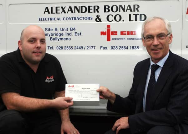Jonathon Rea from Alexander Bonar & Co. Ltd, presents a sponsorship cheque to Ballymena Road Club chairman John Maxwell. INBT40-209AC