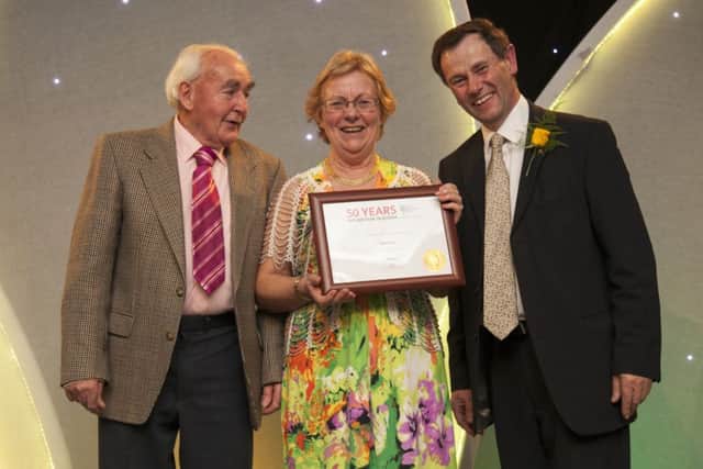 Jackie and Frances Wilson collect Glenarm's Britain in Bloom award at a ceremony in Bristol. Presenting the award is Roger Burnett, chairman of the RHS Britain in Bloom judging panel.  INLT 43-679-CON