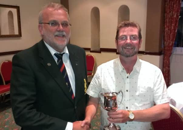 City of Belfast President Peter Long (left) presents the President's Cup to overall winner Des Callaghan.