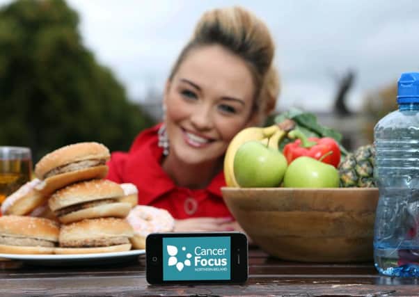 Big Brother finalist Ashleigh Coyle tries out the new Cancer Focus NI FaceUp app  a fun, pop-up-style cartoon that shows young people the downside of too many calories and too much alcohol.