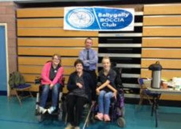 Clare Taggart, Teresa Crawford and Talia McDowell, Ballygally Boccia Club winning team, pictured here with sporting hero Dave McAuley. INLT-43-703-con