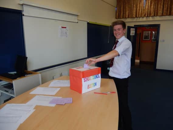 Fionn McCormack casts his vote at Carrickfergus Grammar School. INCT 43-792-CON