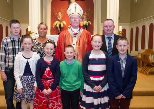 The quintuplet Loughrans from St Mary's P.S. Cabragh, in the parish of Killeeshil, made their Confirmation recently. The famous five of Aine, Alanna, Conan, Caitlin and Aaron celebrated the sacrament with their older brother Niall, parents Noel and Rhonda and Cardinal Sean Brady. INTT1614-700DCA