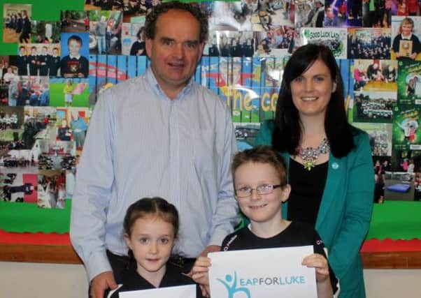Claire O'Hanlon from Derrytresk accepted a fundraising cheque from Sacred Heart PS Rock Principal, Eunan McGinn, and pupils Grace and Sean Girvan,  on behalf of her charity, Leap for Luke. The money was raised after the school held a Rock Day.