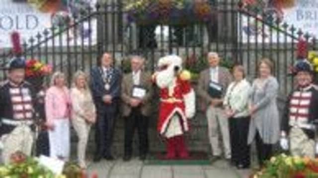 Mayor of Lisburn, Councillor Andrew Ewing (fourth left) and Councillor Jenny Palmer (third right) pictured in Hillsborough with Hillsborough In Bloom members and Britain In Bloom judges.