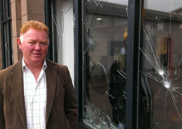 Dr Colin Spence surveys the damage at Tramways Medical Centre. Vandals smashed several windows at the front of the building, leaving the practice with a repair bill in excess of £1,500. INNT 44-504CON