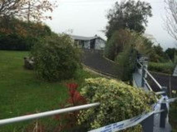 Gardai at the house in Carndonagh where a couple were found dead.