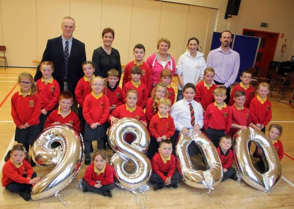 Photographed last week in Ballykeel Primary School were pupils with Rev Martin McNeilly, Sandra Sheeran, principal; Jonathan Fisher, vice-principal and Elizabeth Ewart who presented a £9,800 pounds cheque to Cathy Patton from Heart Beat Trust. This was the proceeds of from the school pupils collection. INBT 44-802H