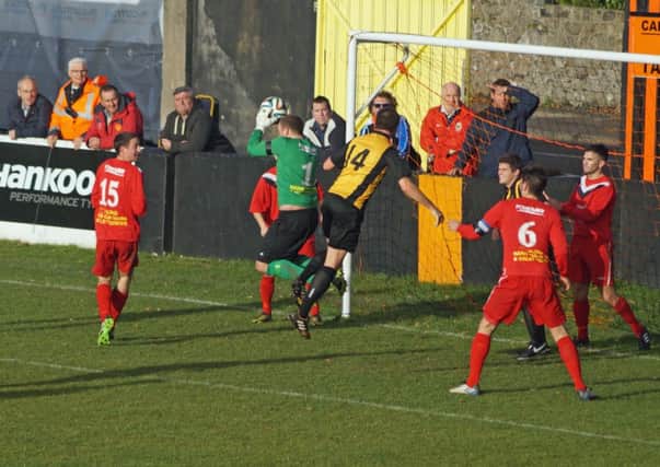 Ballyclare keeper Paddy Flood comes to collect the ball during the derby with Carrick Rangers.