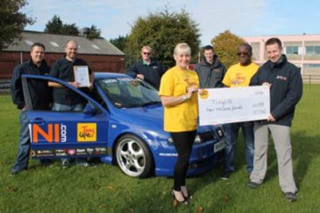 Gethin Evans (Islandmagee), Nigel Lamont (Comber), Gavin White (Ballymoney), Andrew Maxwell (Comber) and John Middleton (Comber) presenting a cheque for £10,000 to Kimberly Hill and Reggie Clarke from Friends of TinyLife, Belfast. INBM44-14S