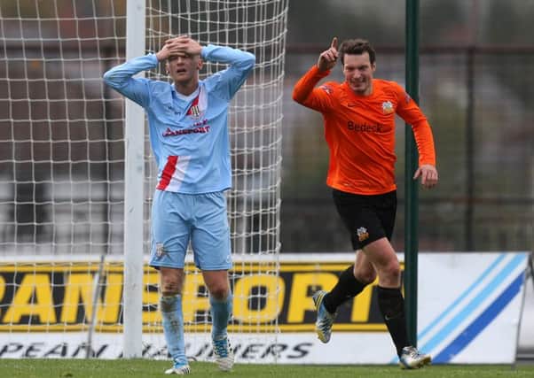 Ballymena United defender Stephen McBride holds his head in his hands as Glenavon's Kyle Neill wheels away in celebration after opening the scoring in today's Danske Bank Premiership game at the Showgrounds. Picture: Press Eye.